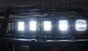 Auxiliary LED light pods on a grille guard